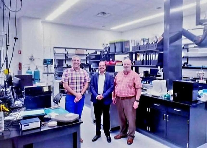 Dr Hegde with two colleagues in a research laboratory